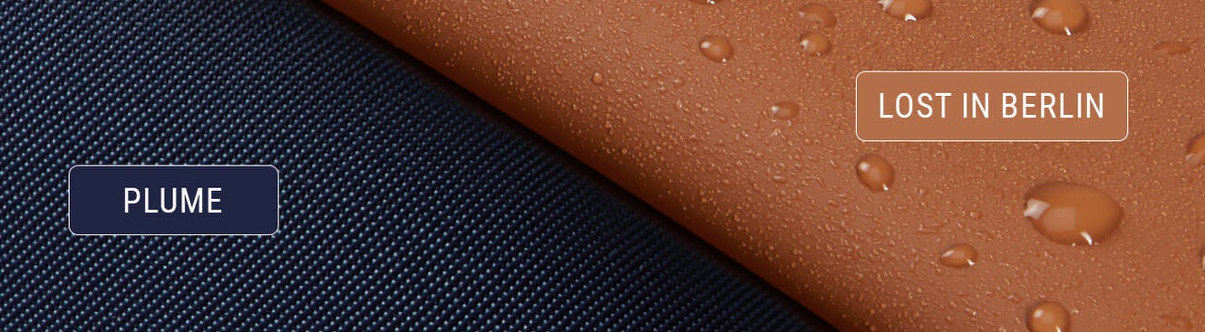 Plume material shows an up close image of it's Twill Nylon up against the Lost in Berlin coated, rubber-effect, water resistant canvas. 